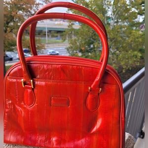 Reddish orange genuine eelskin purse or handbag.